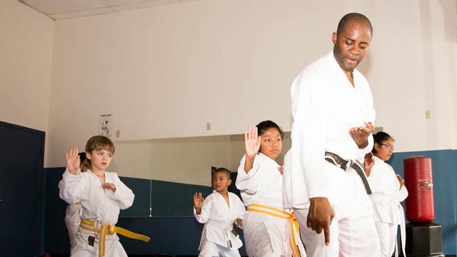 Sensei Alex Ndem teaching children martial arts class students in Houston.